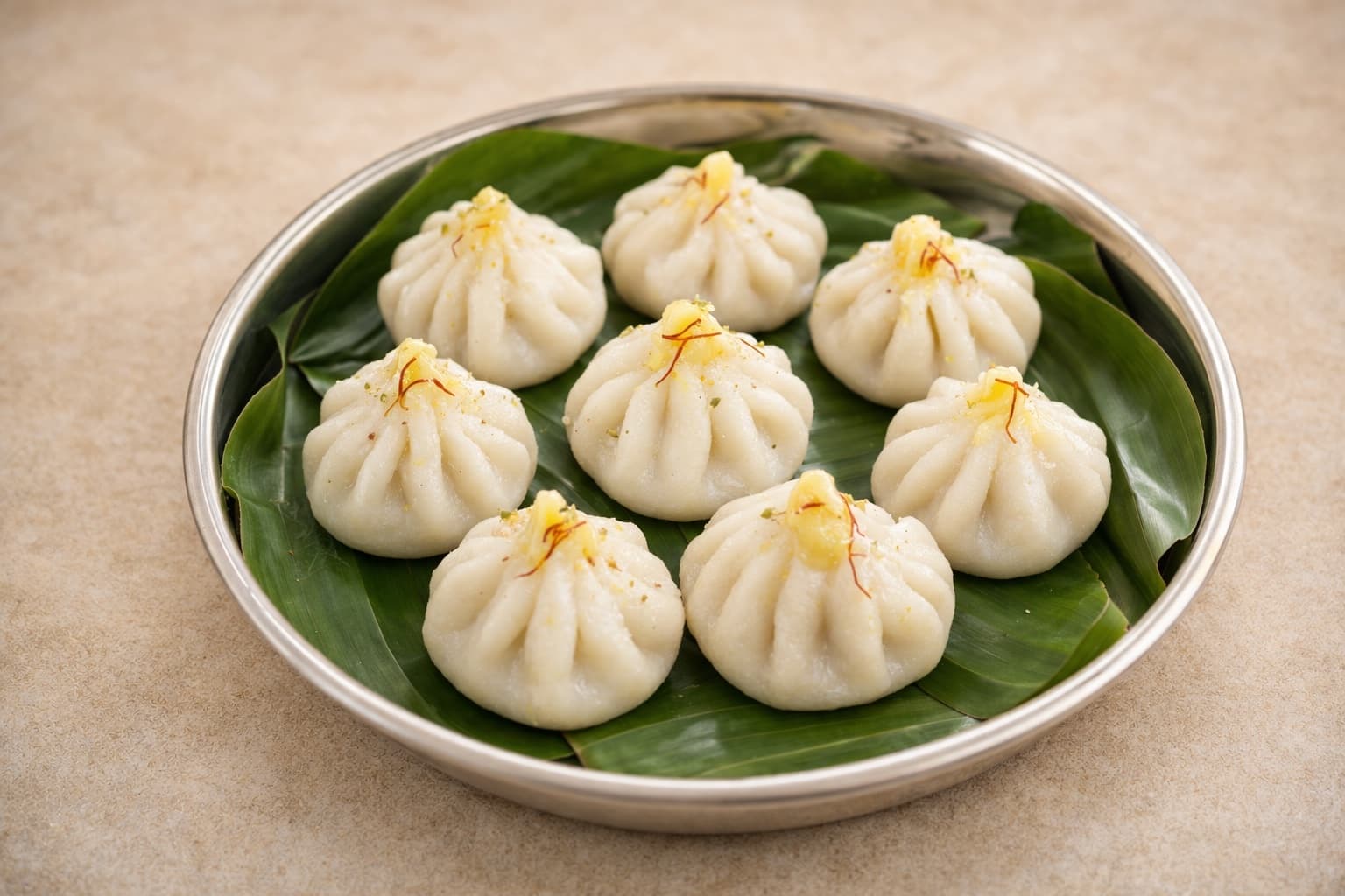 Modaks being shaped by hand in the Moduk & Co kitchen